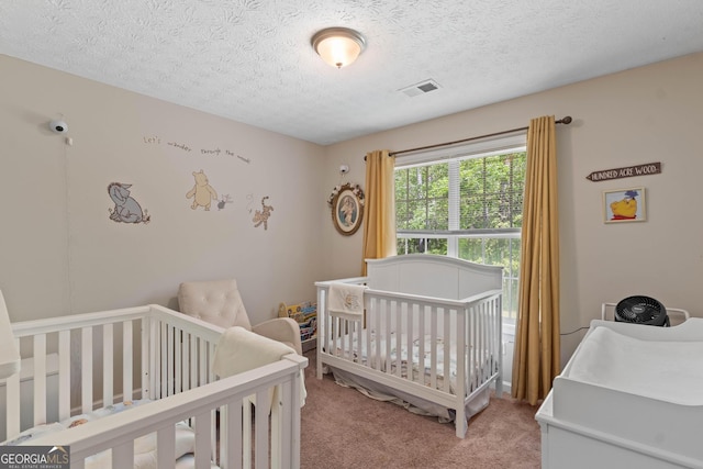 1012 Miss Amber Way, Locust Grove, GA 30248 - bedroom with light carpet, a nursery area, and a textured ceiling