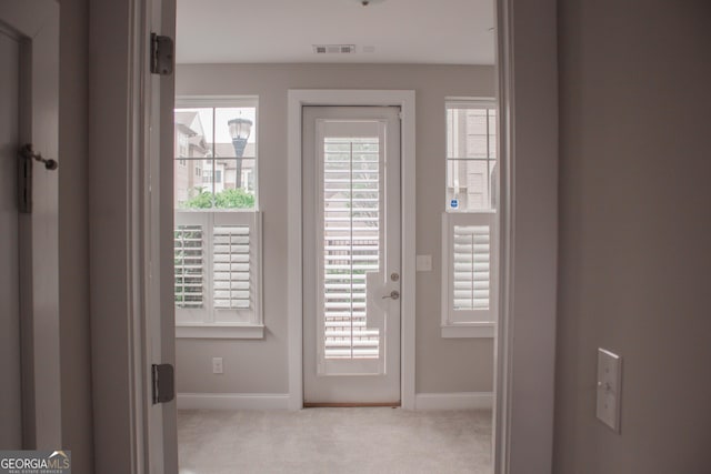 600 Broadview Ter NE, Atlanta, GA 30324 - doorway to outside featuring visible vents, baseboards, carpet flooring, and a wealth of natural light