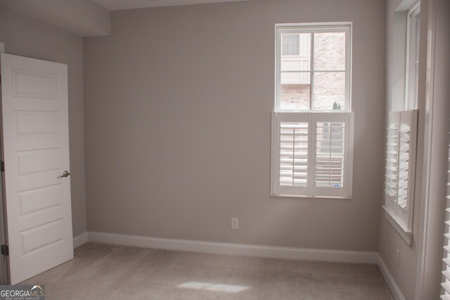 600 Broadview Ter NE, Atlanta, GA 30324 - empty room featuring light colored carpet, baseboards, and a healthy amount of sunlight