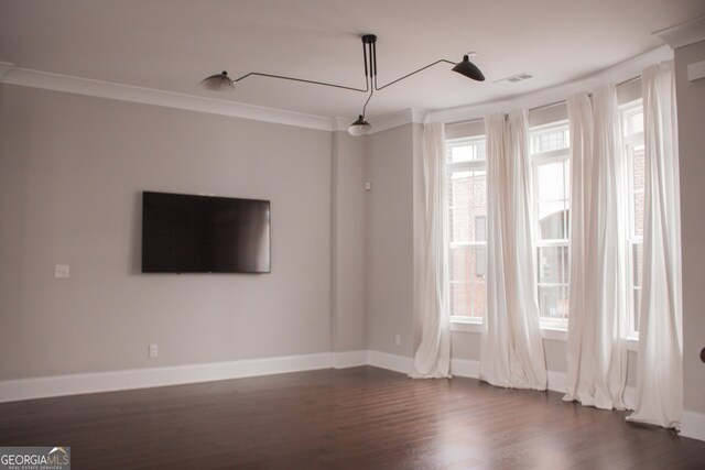 600 Broadview Ter NE, Atlanta, GA 30324 - spare room featuring crown molding, baseboards, visible vents, and dark wood finished floors