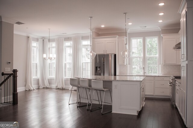 600 Broadview Ter NE, Atlanta, GA 30324 - kitchen with a center island, range hood, white cabinetry, appliances with stainless steel finishes, and dark wood-type flooring