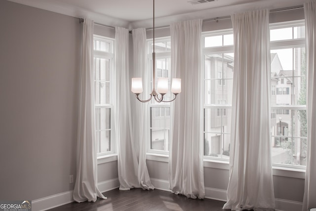 600 Broadview Ter NE, Atlanta, GA 30324 - interior space with baseboards, a healthy amount of sunlight, a notable chandelier, and dark wood finished floors