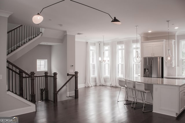 600 Broadview Ter NE, Atlanta, GA 30324 - interior space featuring dark wood-type flooring, light stone countertops, baseboards, stainless steel fridge, and white cabinetry