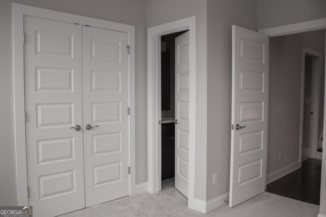600 Broadview Ter NE, Atlanta, GA 30324 - unfurnished bedroom with ensuite bath, light carpet, a closet, and baseboards