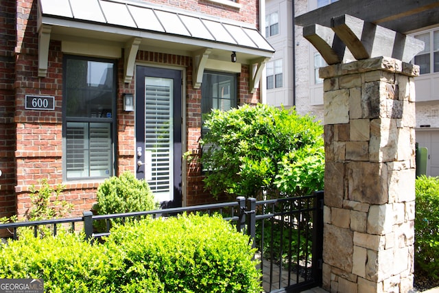 600 Broadview Ter NE, Atlanta, GA 30324 - property entrance featuring a standing seam roof, brick siding, and metal roof