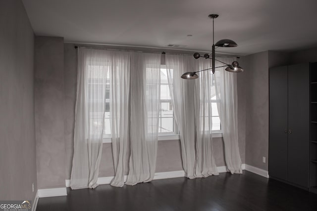 600 Broadview Ter NE, Atlanta, GA 30324 - unfurnished dining area with visible vents, baseboards, an inviting chandelier, and dark wood-style flooring