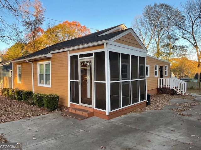view of home's exterior with a sunroom