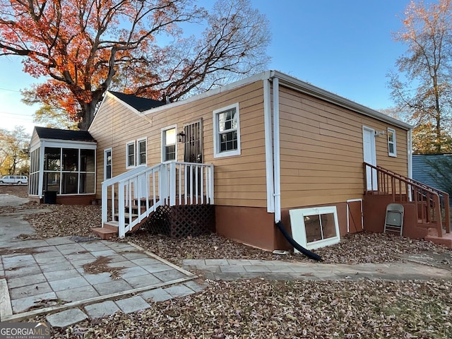 exterior space featuring a patio area and a sunroom