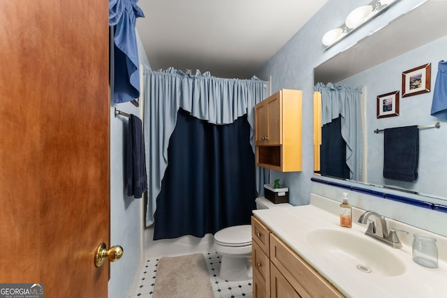 bathroom featuring vanity, tile patterned flooring, and toilet