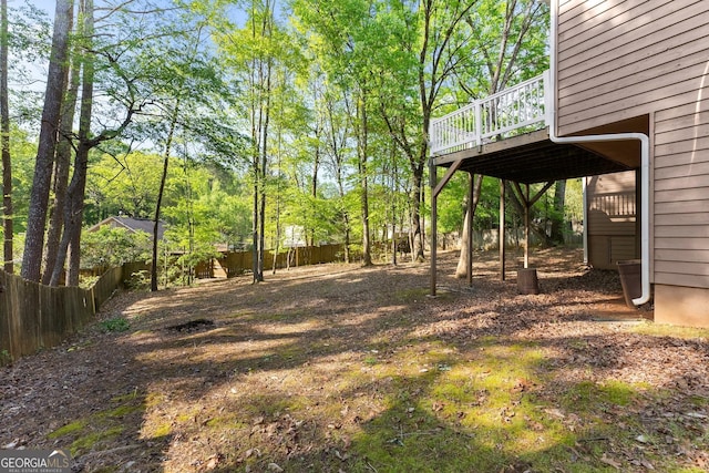 view of yard with fence and a wooden deck