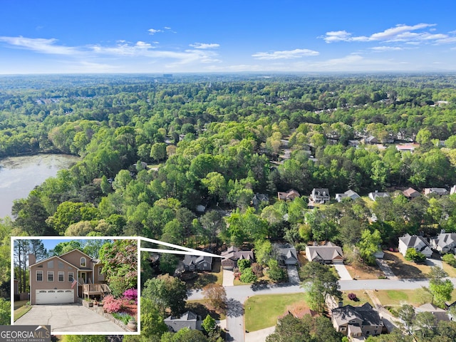 bird's eye view featuring a view of trees and a water view