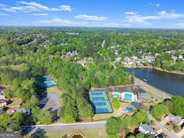 aerial view featuring a forest view and a water view
