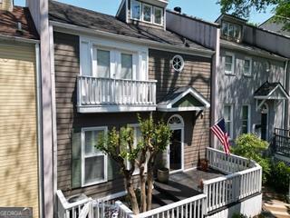 back of property with a balcony