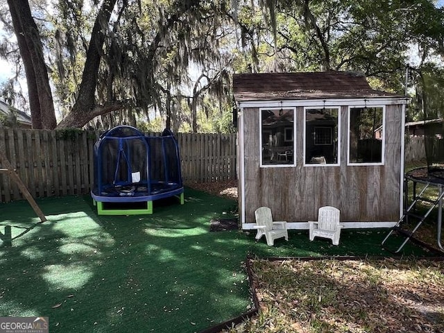 1163 Bristol Hammock Cir, Kingsland, GA 31548 - fenced backyard with a trampoline and a storage unit