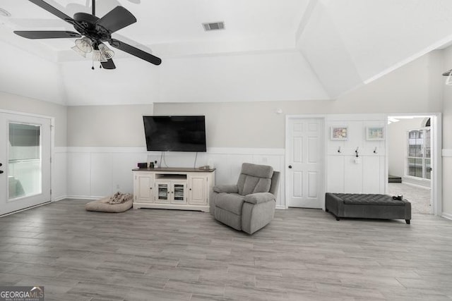 1163 Bristol Hammock Cir, Kingsland, GA 31548 - living area with vaulted ceiling, a wainscoted wall, light wood-style flooring, and ceiling fan
