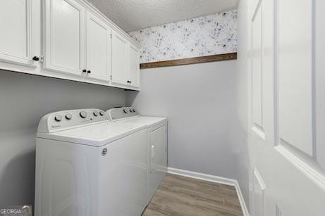 1163 Bristol Hammock Cir, Kingsland, GA 31548 - laundry area with washing machine and clothes dryer, cabinet space, wood finished floors, and a textured ceiling