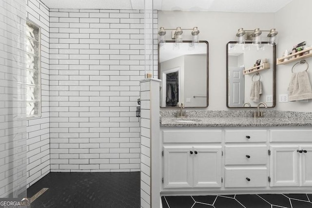 1163 Bristol Hammock Cir, Kingsland, GA 31548 - bathroom featuring double vanity, tiled shower, and tile patterned floors
