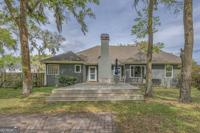 1163 Bristol Hammock Cir, Kingsland, GA 31548 - back of house featuring a deck, a chimney, stucco siding, and roof with shingles