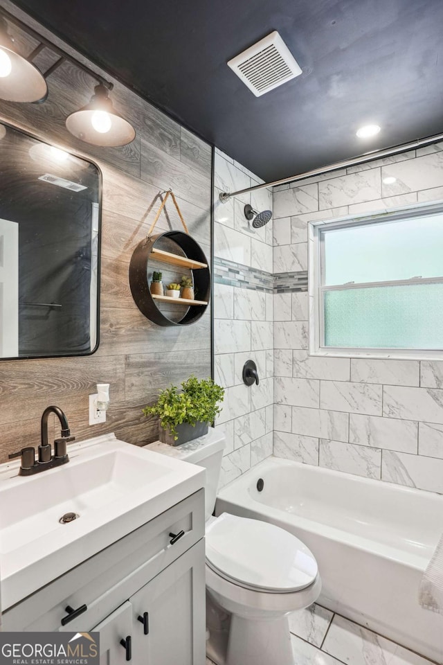 full bath with toilet, bathtub / shower combination, visible vents, marble finish floor, and vanity