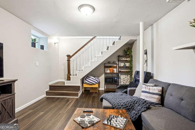 living area featuring stairway, baseboards, and wood finished floors