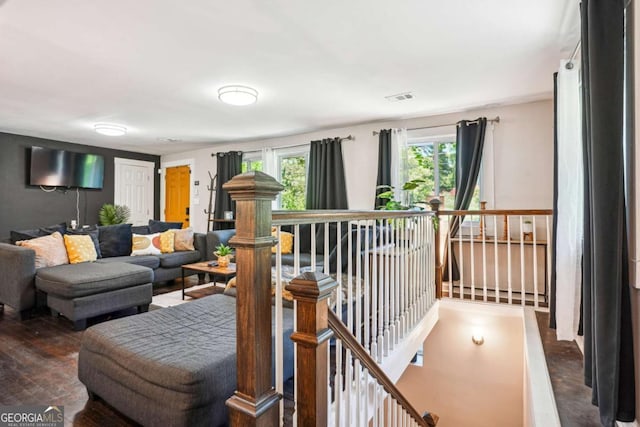 living area featuring wood finished floors and visible vents
