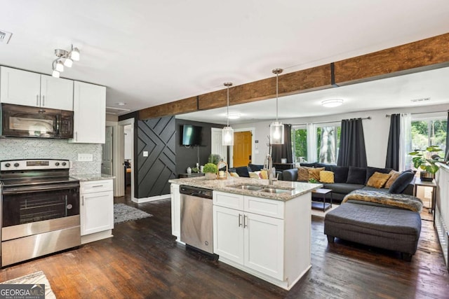 kitchen featuring appliances with stainless steel finishes, open floor plan, dark wood-style flooring, and a sink