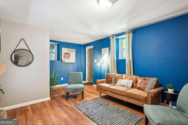 living area with wood finished floors and baseboards