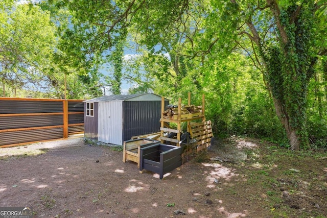 view of shed featuring fence