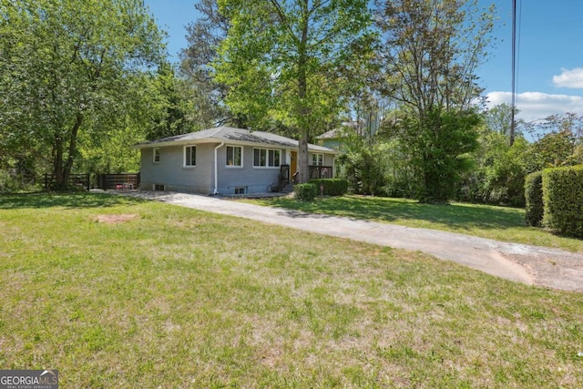 view of front of home with a front lawn and fence