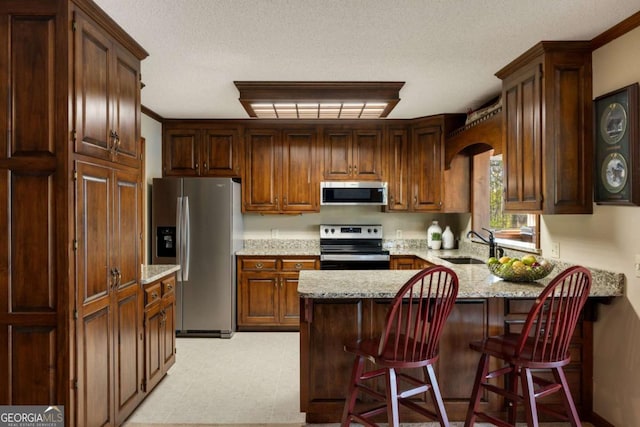 736 Cedar Ridge Rd, Hartwell, GA 30643 - kitchen featuring a sink, light floors, a peninsula, appliances with stainless steel finishes, and light stone countertops