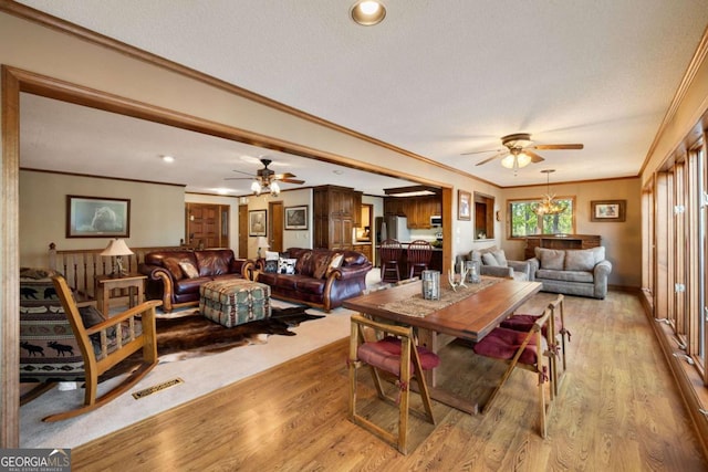 736 Cedar Ridge Rd, Hartwell, GA 30643 - dining area featuring crown molding, light wood-style flooring, visible vents, and a ceiling fan