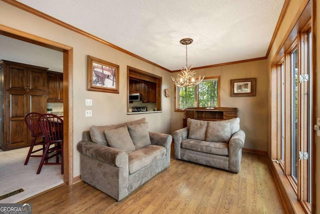 736 Cedar Ridge Rd, Hartwell, GA 30643 - living area with baseboards, an inviting chandelier, light wood-style floors, and ornamental molding