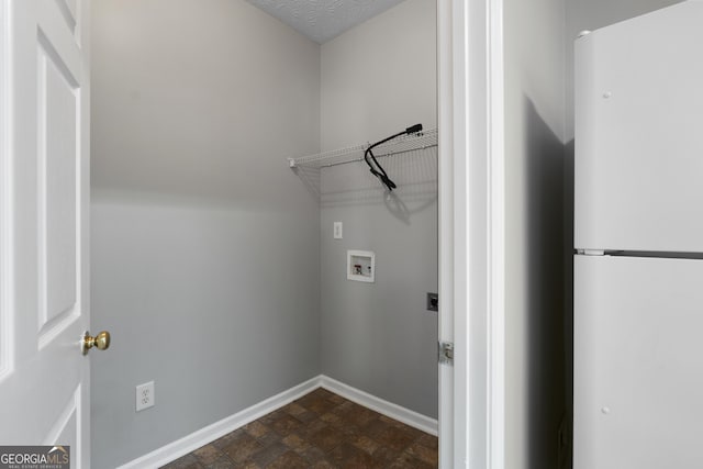 laundry room with baseboards, stone finish flooring, laundry area, and washer hookup