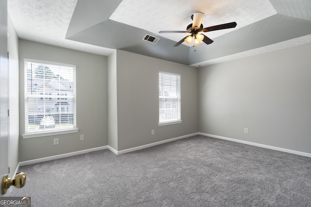 unfurnished room featuring a wealth of natural light, carpet flooring, and visible vents