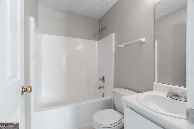 bathroom with toilet, vanity, a textured ceiling, and tub / shower combination