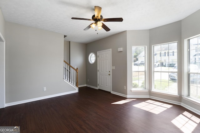 foyer featuring stairway, a textured ceiling, ceiling fan, dark wood finished floors, and baseboards