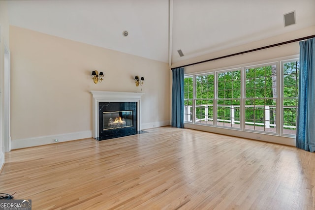3105 Birchton St, Johns Creek, GA 30022 - unfurnished living room with wood finished floors, a high end fireplace, baseboards, and high vaulted ceiling