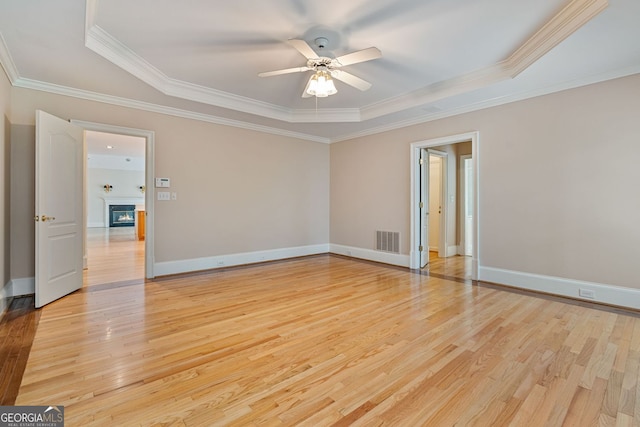 3105 Birchton St, Johns Creek, GA 30022 - unfurnished room featuring a tray ceiling, a ceiling fan, light wood-style flooring, crown molding, and baseboards