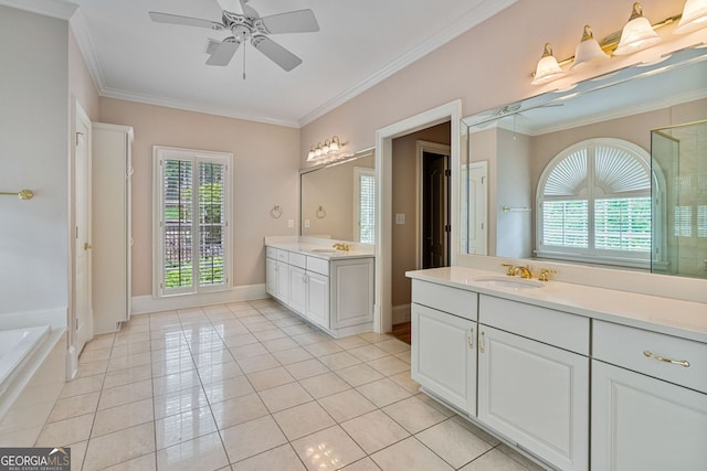 full bath with tile patterned floors, crown molding, ceiling fan, two vanities, and a garden tub