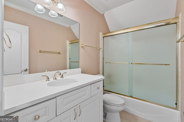full bath with toilet, vanity, bath / shower combo with glass door, and ornamental molding
