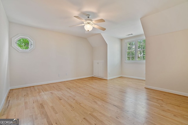 additional living space featuring wood finished floors, a ceiling fan, baseboards, and lofted ceiling