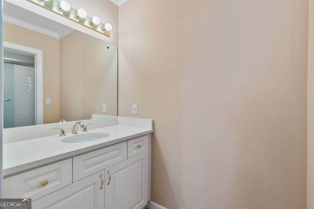 bathroom featuring crown molding, vanity, and baseboards