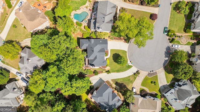 aerial perspective of suburban area featuring a pool area