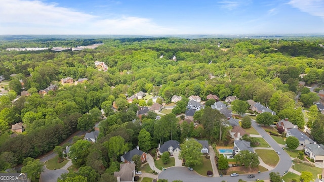 aerial view of residential area featuring a heavily wooded area