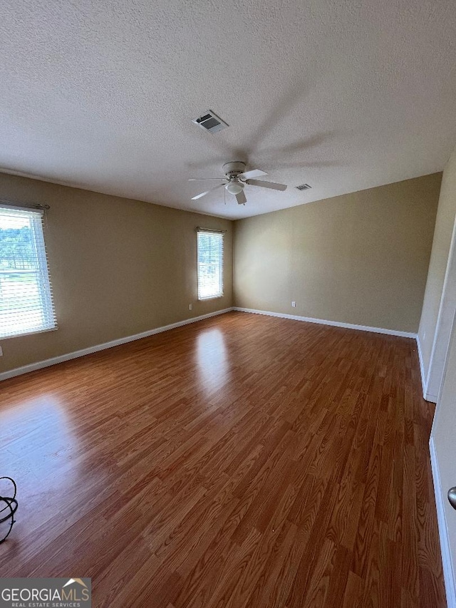 1640 Hg Miles Dr NE, Townsend, GA 31331 - spare room with a textured ceiling, baseboards, visible vents, a ceiling fan, and wood finished floors