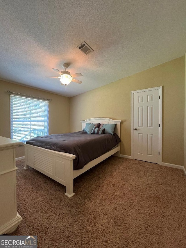 1640 Hg Miles Dr NE, Townsend, GA 31331 - carpeted bedroom featuring a textured ceiling, visible vents, baseboards, and ceiling fan