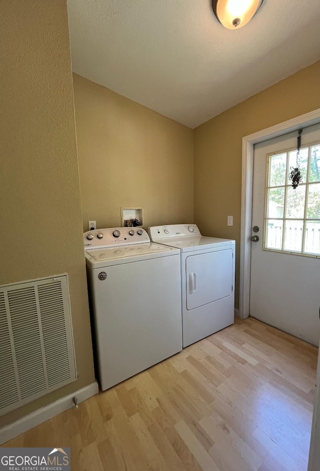 1640 Hg Miles Dr NE, Townsend, GA 31331 - laundry area with separate washer and dryer, visible vents, laundry area, and light wood-type flooring