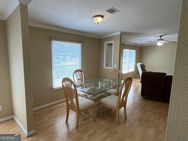 1640 Hg Miles Dr NE, Townsend, GA 31331 - dining area with light wood-style floors, ceiling fan, baseboards, ornamental molding, and visible vents