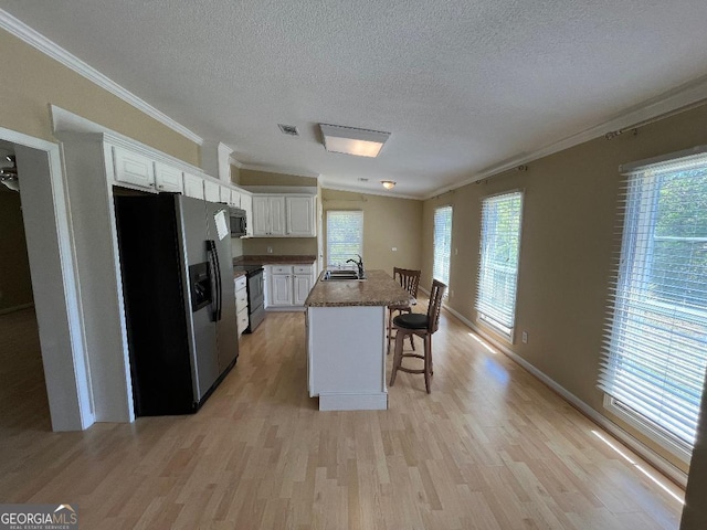 1640 Hg Miles Dr NE, Townsend, GA 31331 - kitchen featuring a sink, a textured ceiling, black range with electric stovetop, crown molding, and stainless steel fridge with ice dispenser
