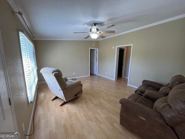 1640 Hg Miles Dr NE, Townsend, GA 31331 - living room featuring ceiling fan, ornamental molding, light wood-style floors, and visible vents